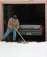Chuck shovels snow. Photo by Susan Pfannmuller